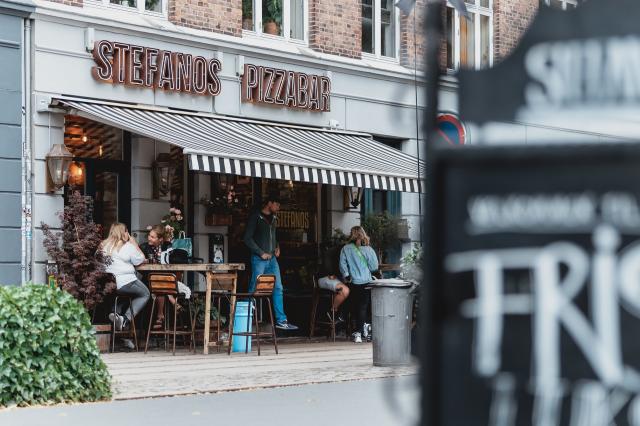 People at a pizzeria in Norrebro, Copenhagen, Denmark. Photo by Febiyan on Unsplash